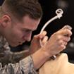 Student in military fatigues in paramedic classroom